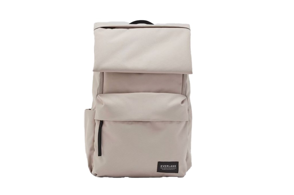 A white backpack with a black strap